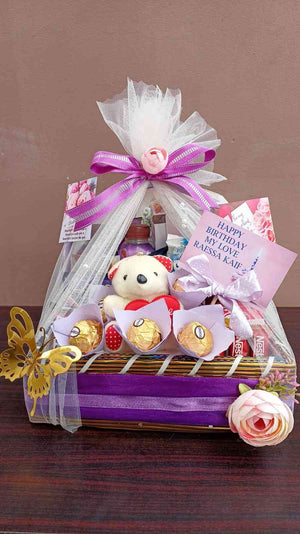 Beautiful purple-themed birthday gift basket with Ferrero Rocher chocolates, a teddy bear, personalised messages, and decorative ribbons, perfect for celebrations.