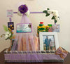 Purple-themed anniversary gift basket with personalised messages, a framed photo, juice bottles, and elegant floral decorations, perfect for a special celebration.