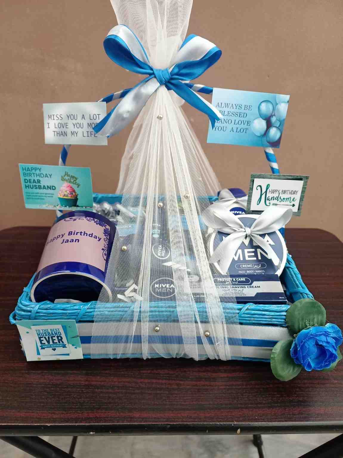 Blue-themed husband birthday gift basket with Nivea men’s products, personalised messages, and elegant blue and white ribbons for a thoughtful celebration.